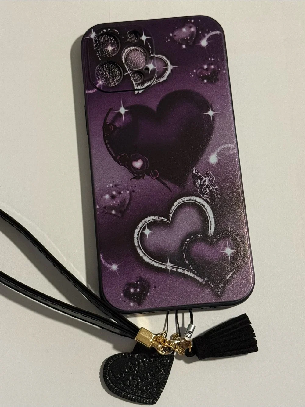Purple Heart Pattern Phone Case with Wrist Strap for Apple 16 pro max.